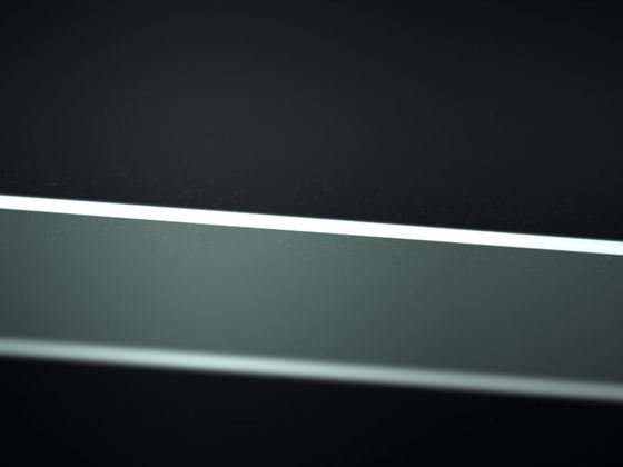 Close view of a glass edge under water, the polished chamfer running as a bright line through the dark.